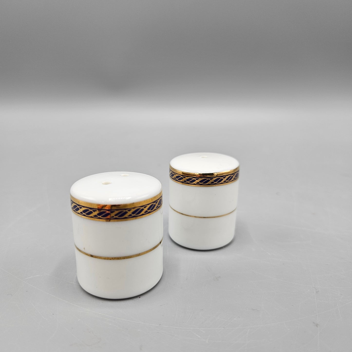Pair White Porcelain Individual Salt and Pepper Shakers - Black and Gold Band