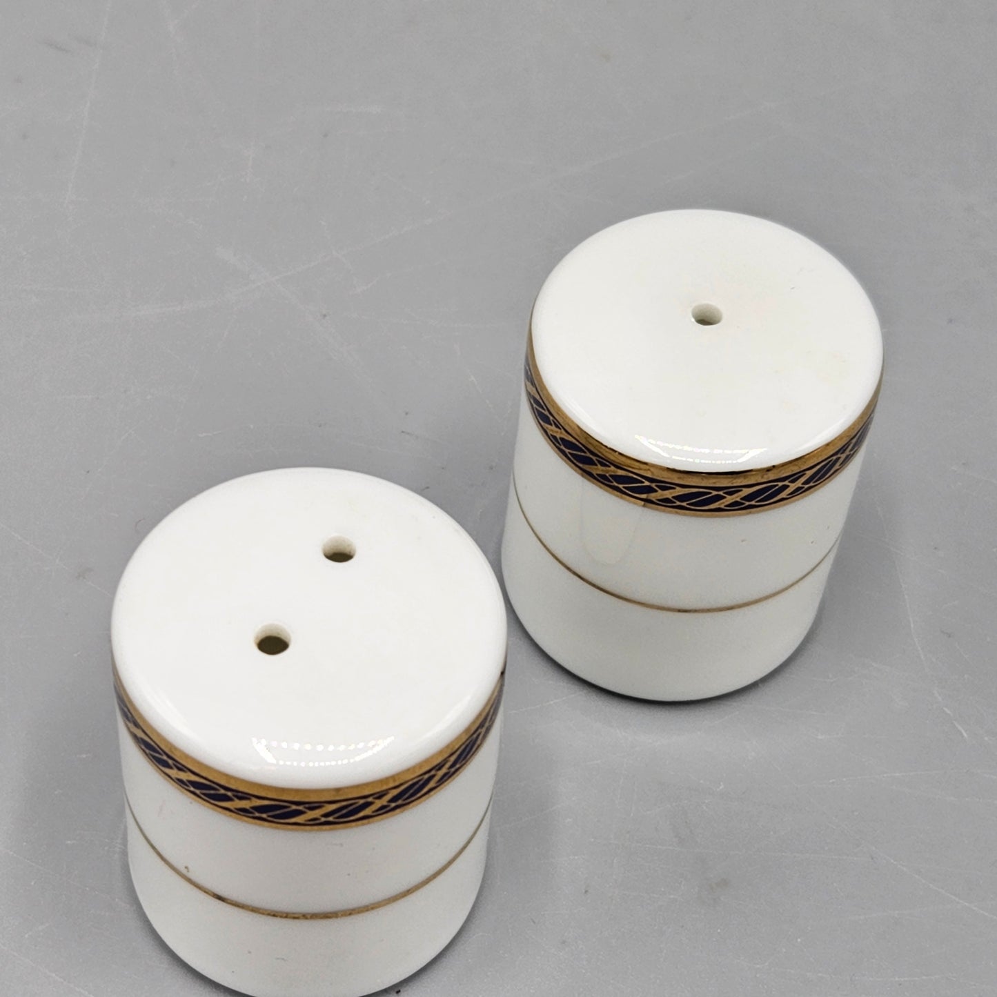 Pair White Porcelain Individual Salt and Pepper Shakers - Black and Gold Band