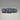 Vintage Art Deco Filigree Bar Pin with Blue Crystal Stones