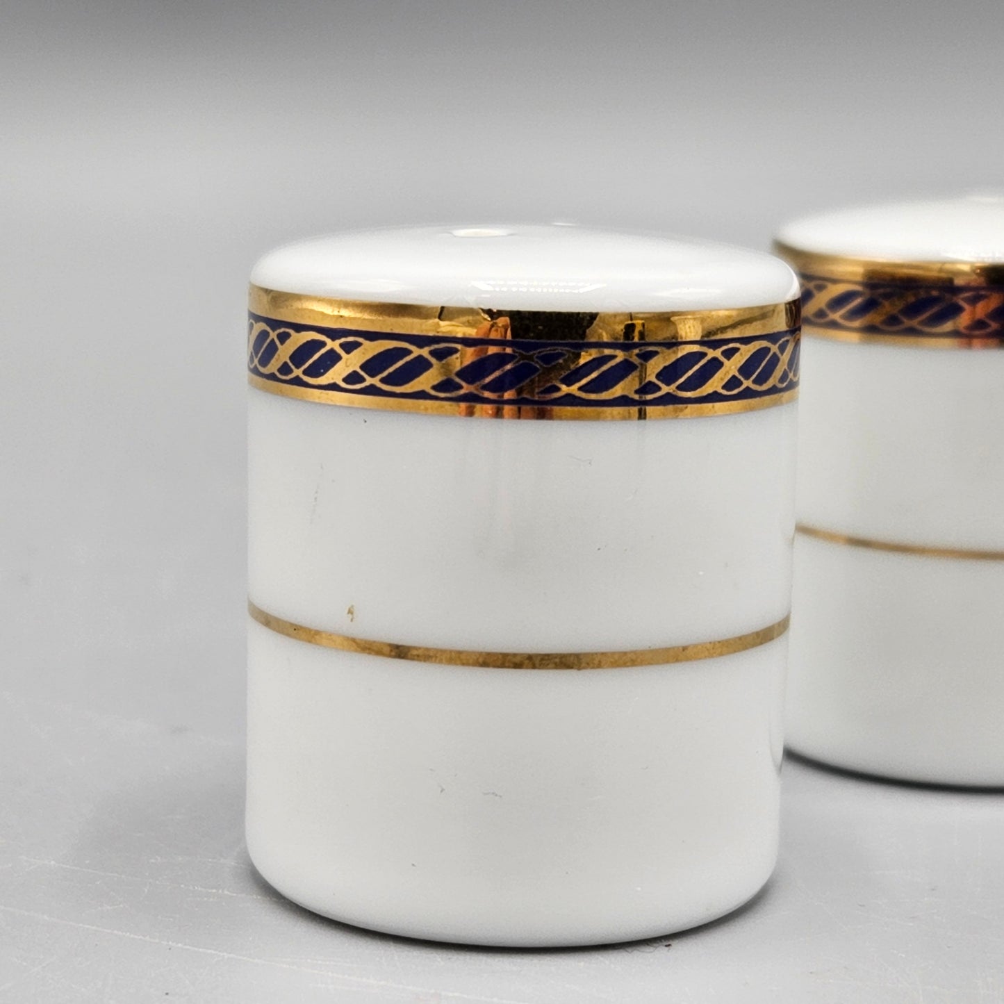 Pair White Porcelain Individual Salt and Pepper Shakers - Black and Gold Band
